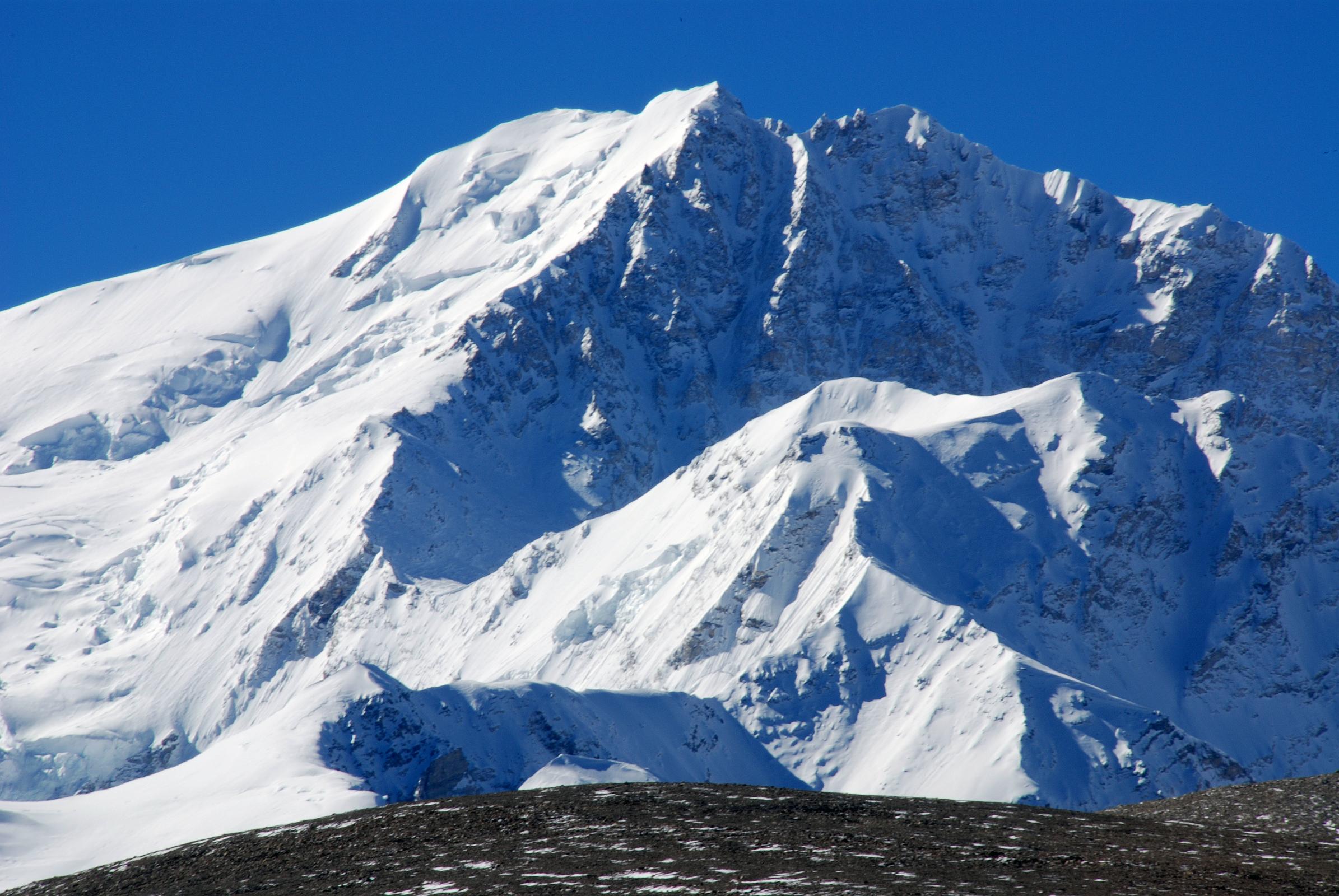 22 Shishapangma Main, Central And West Summits And Yebokangal Ri Close Up From Trek Towards Shishapangma North Advanced Base Camp Shishapangma Main Summit to the left, Central Summit in the middle and the West Summit in shade above the north face on the right from the trek towards Shishapangma North Advanced Base Camp. Yebokangal Ri (7365m, Jebo Kangri) is just below the North Face.